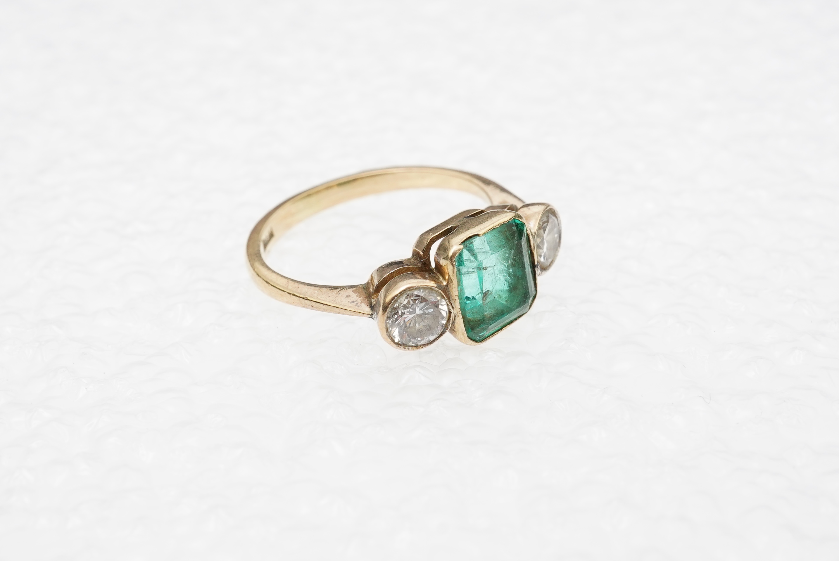 An emerald and diamond ring